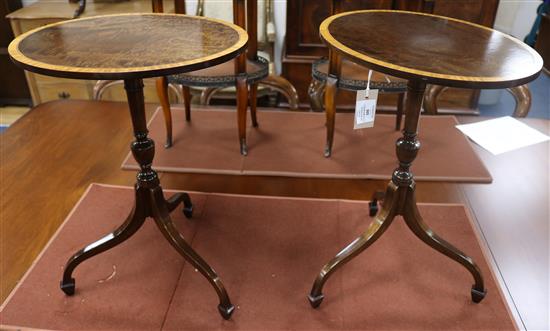 A pair of Georgian style mahogany oval tripod tables W.43cm
